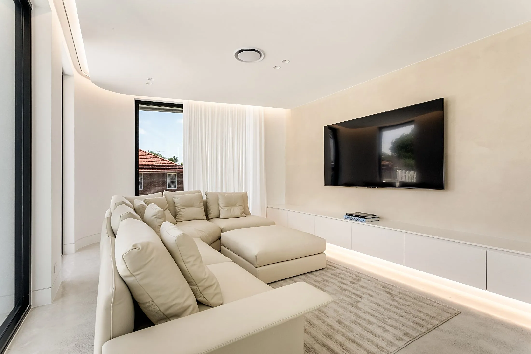Living room with a white wall-hung TV unit and LED lighting, Lilyfield